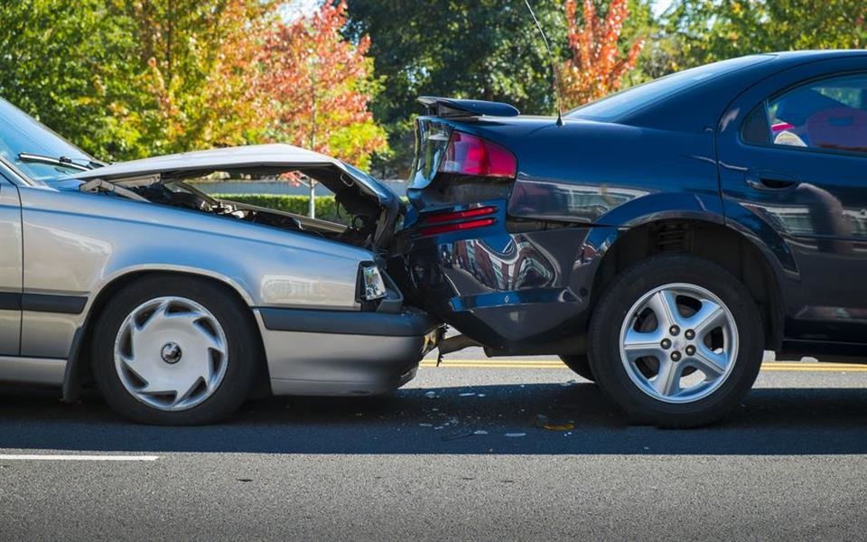 One type of staged collision called the "swoop and squat" involves scammers pulling in front of an innocent driver, then slamming on their brakes to ensure the driver doesn't have enough time to stop. This makes it appear like the innocent driver is at fault. (Robert Crum/Shutterstock)