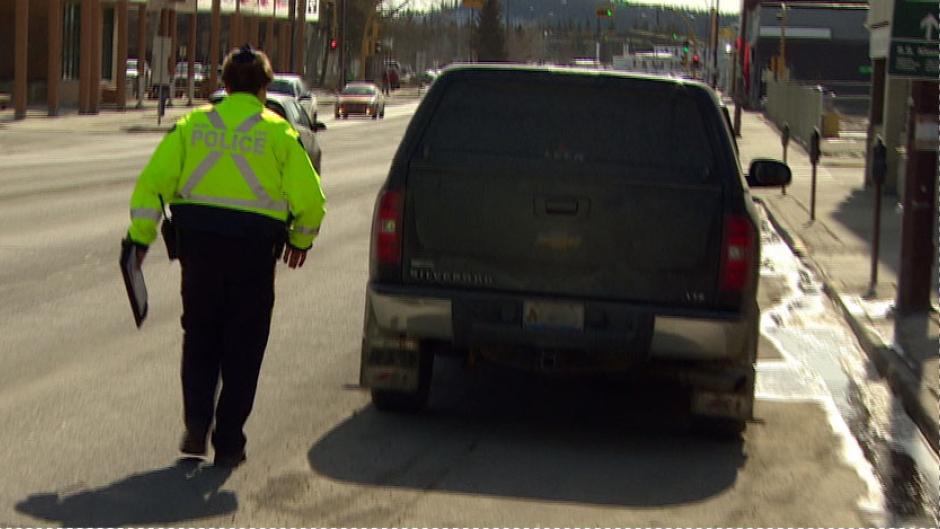 Whitehorse RCMP pull over a driver during a crackdown last year on hand-held cellphone use while driving. A Yukon judge has ruled that using a cellphone lodged between a shoulder and an ear can be considered hands-free, and is not illegal. (CBC) 