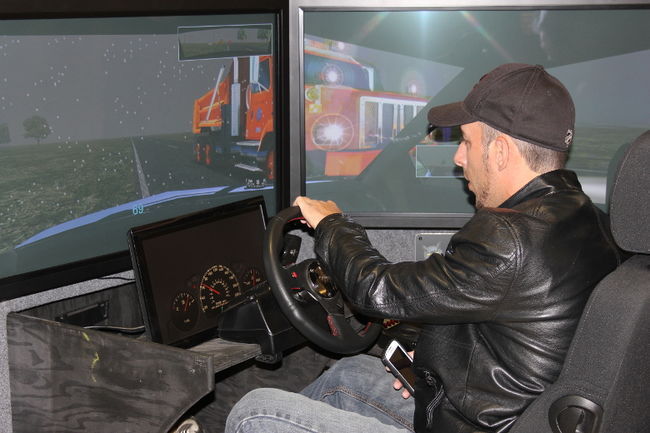 Cory Derouchie trying out the distracted driving simulator on Monday May 11, 2015 in Cornwall, Ont. The simulator will be on available to try at Cornwall Square Tuesday and Wednesday. Lois Ann Baker/Cornwall Standard-Freeholder/Postmedia Network