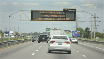 highway sign saying "Don't misuse the HOV lane."