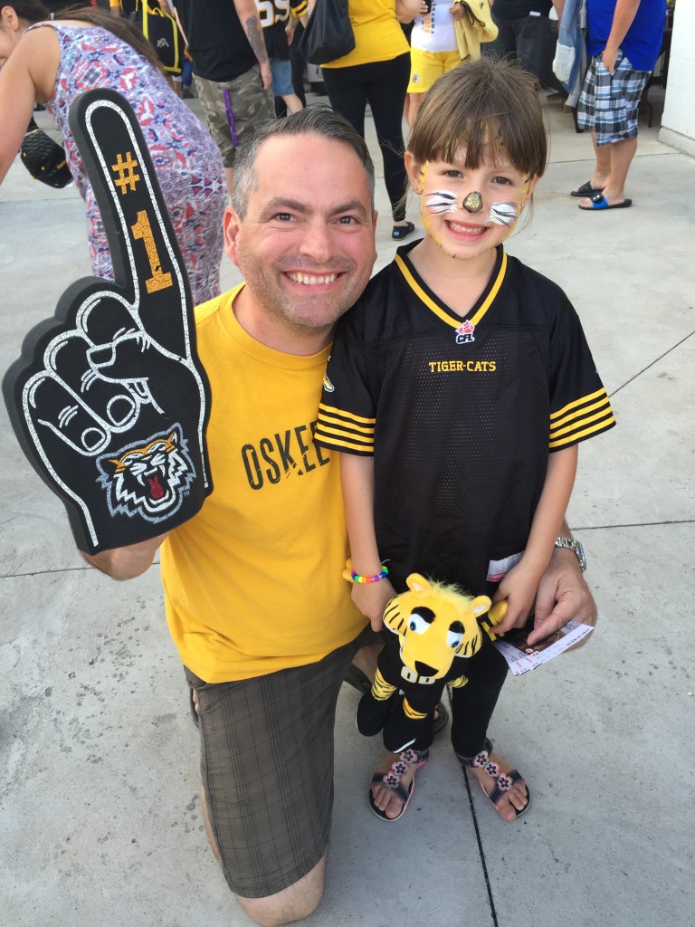 Ivon Fournier, president of XPolice, and his daughter Maggie at a Ticats game