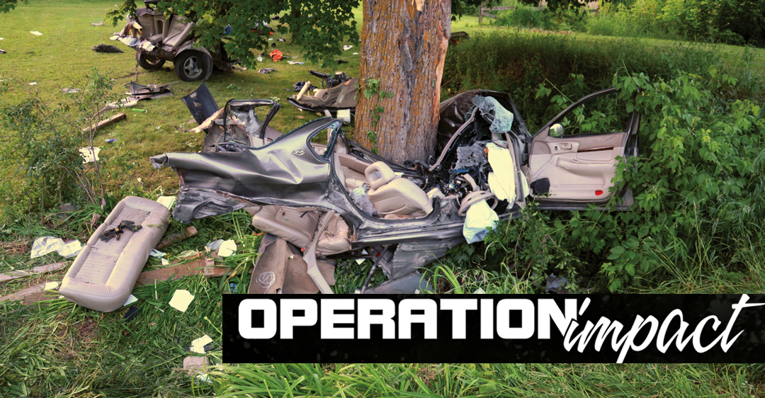 Image of an utterly destroyed vehicle wrapped around a tree.