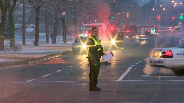 Toronto police officer standing near a crash scene.