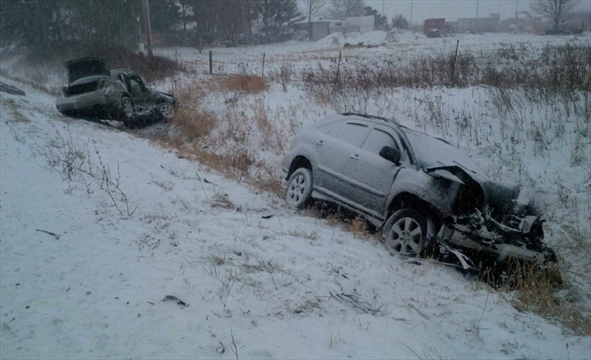 crashed vehicle in a snowy ditch