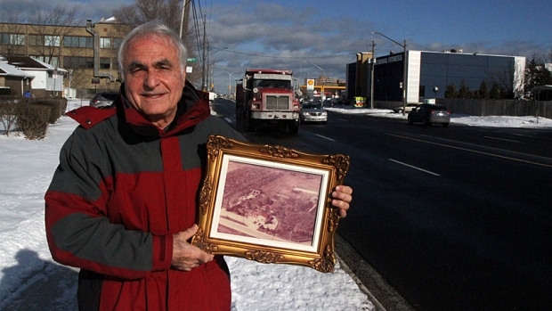 Fred Pizzoferrato showing off a photo of his area in 1950.