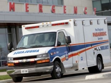Picture of an ambulance outside of the emergency wing of a hospital.