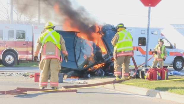Firefighters put out the fire from the SUV, which burst into flames shortly after the collision. (CBC)