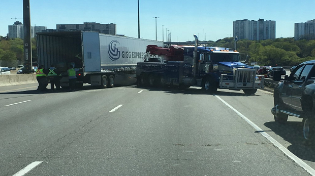 This police photo from Twitter shows a tractor-trailer collision blocking eastbound lanes on Highway 401. (@OPP_HSD/Ontario Provincial Police)