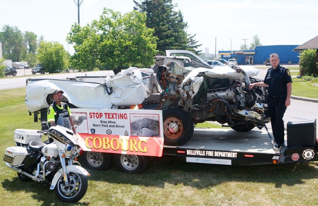 Cobourg Police Constable Frank Francella and Cobourg Fire Department Captain Scott MacDonald with the distracted driving display that will be at the Community Connections Expo this coming weekend in Cobourg. PETE FISHER/Northumberland Today