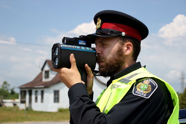 Cst. Ryan Attoe looking through a Lidar tracking device.