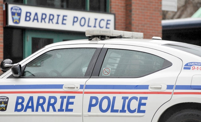 A cropped side view of a Barrie Police car.