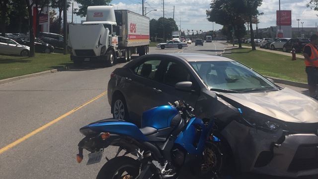 A picture of the crashed motorcycle embedded in the car it collided with.